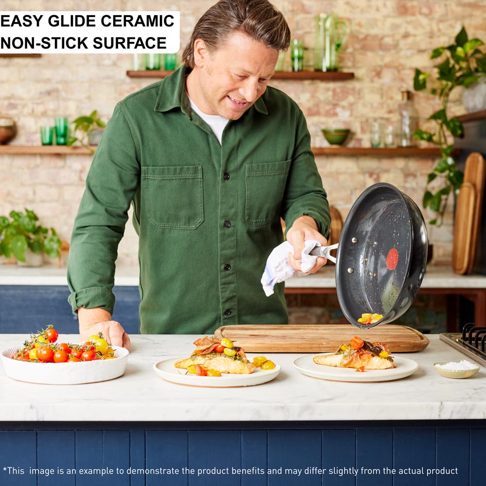 Jamie Oliver sliding food from frypan onto salmon - Robins Kitchen