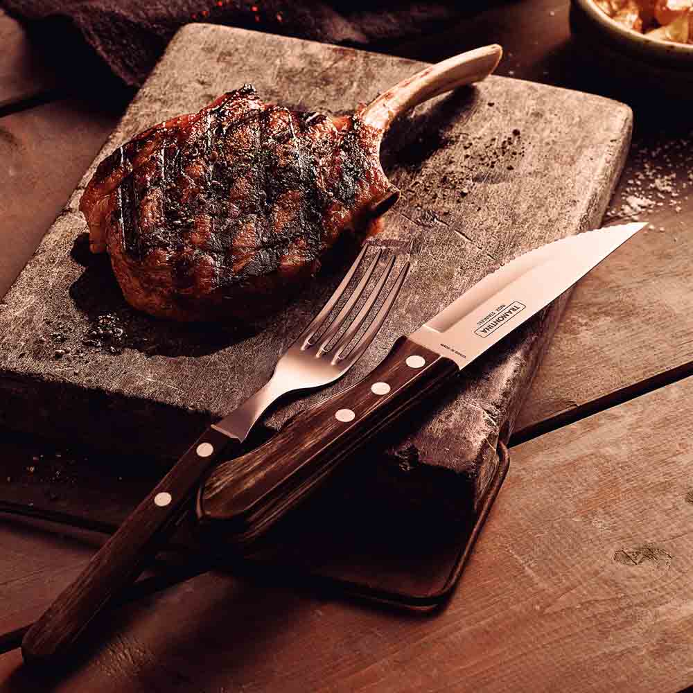 steak knife and fork set with side of charred cutlet on wooden board - Robins Kitchen