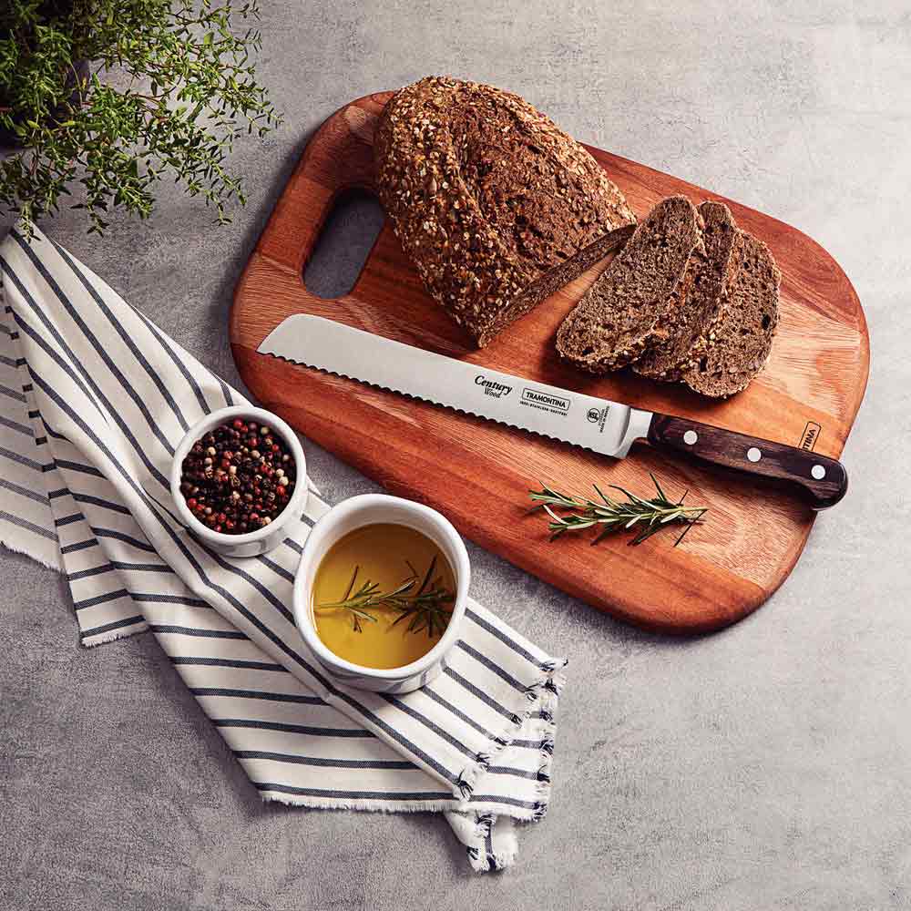 loaf of bread on a chopping board with slices of bread and a bread knife - Robins Kitchen