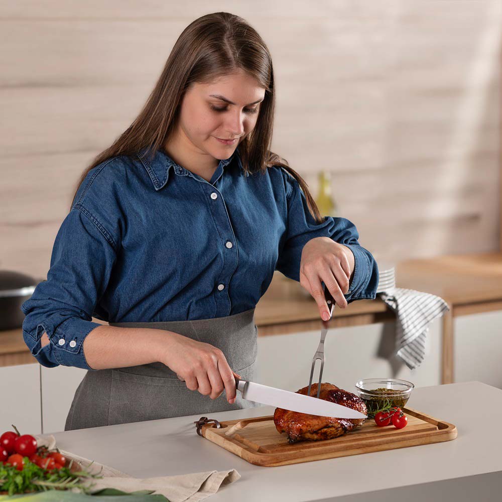 woman carving roast at kitchen bench with Utility Carving Knife - Robins Kitchen