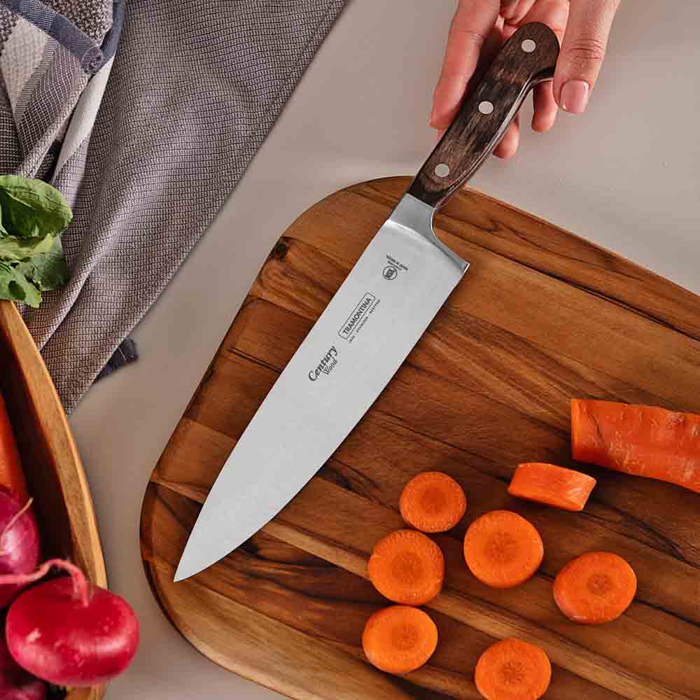 woman chopping carrot at kitchen counter with chef knife - Robins Kitchen